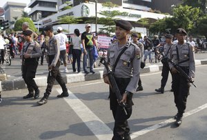 Indonesian police patrol outside the Starbucks cafe where Thursday's attack in Jakarta, Indonesia, Sunday, Jan. 17, 2016.