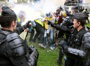 French riot police spay activists with pepper spray to keep them from getting closer to a...