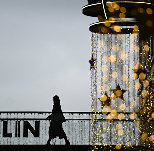 A woman walks past a Christmas decoration at a shopping mall in Berlin November 26, 2015