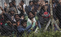 Migrants, most of them from Pakistan, protest against the EU-Turkey deal on migration inside the entrance of Moria camp in the Greek island of Lesbos on April 5, 2016