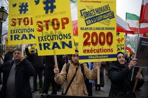 Supporters of Maryam Rajavi, President of the National Council of Resistance of Iran, demonstrate against the Iranian President Hassan Rouhani's visit in Paris, Wednesday, Jan. 27, 2016.