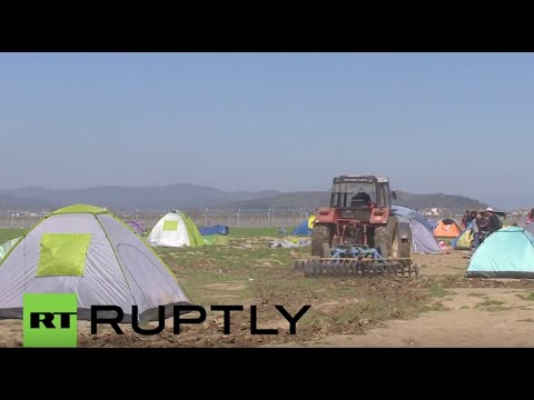 Greece: Farmer PLOUGHS land where refugees are living in tents