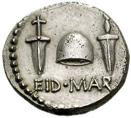 Here's a photo of a silver coin with the caption EID MAR. Above the caption are two daggers, flanking a Liberty Cap to the left and the right.