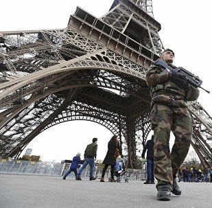 French military patrol near the Eiffel Tower the day after a series of deadly attacks in Paris , November 14, 2015