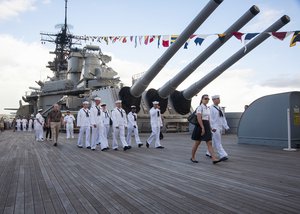 Sailors attend a Veterans Day sunset service aboard the Battleship Missouri Memorial at Joint Base Pearl Harbor-Hickam. Veterans, along with friends and family members, gathered with service members from all branches of the military to honor those that have served. (U.S. Navy photo by Mass Communication Specialist 3rd Class Johans Chavarro/Released).