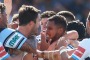 Wild bunch: Sharks and Titans players get up close and personal during Sunday's NRL clash.