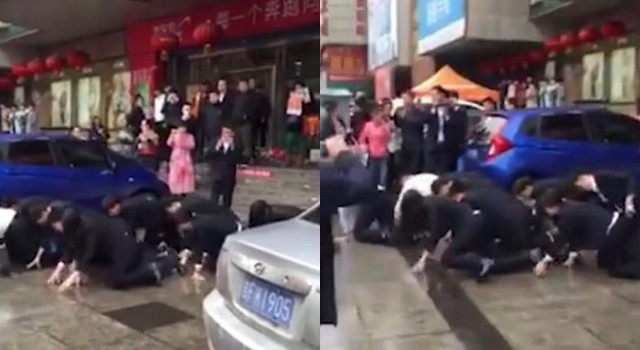 A dozen employees 'voluntarily' crawl on all fours through the street after failing to reach sales targets