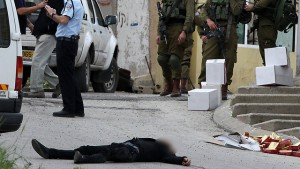 Abed al-Fattah Yusri al-Sharif, 21, lying dead in the street in Hebron, March 24, 2016