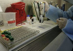 A Thai technician works on blood samples of volunteers at a lab at the Armed Forces Research Institute of Medical Sciences in Bangkok, Thailand Friday, Sept. 25, 2009. U.S. military and Thai health officials told a news conference in Bangkok that results of an earlier AIDS vaccine trial at the lab showed the vaccine cut the risk of becoming infected with HIV by more than 31 percent. The result came after the world's largest AIDS vaccine trial of more than 16,000 volunteers in Thailand.