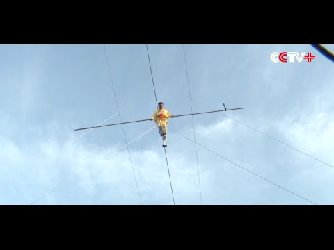 Chinese Stilt Walker Succeeds in High Wire Challenge