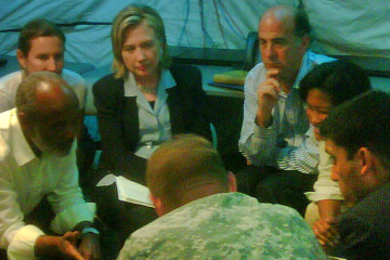 U.S. Secretary of State Hillary Rodham Clinton, USAID Administrator Raj Shah and Deputy Commander SOUTHCOM General P.K. Keen meet with President Rene Preval in a tent at the Prince-au-Port airport, Haiti, Jan. 16, 2010. Photo by USAID on Flickr.