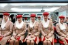 Flight attendant students for Emirates pose in the image and uniform classroom at the Emirates Aviation College in Dubai.