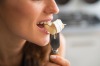 Closeup on young woman eating camembert