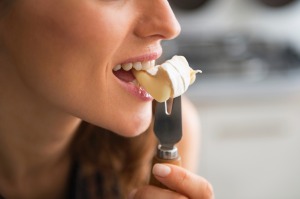 Closeup on young woman eating camembert