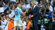 Manuel Pellegrini shakes the hand of Sergio Aguero as he leaves the field