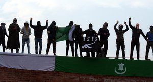 Kashmiri muslim protestors hold = Pakistani flag  and ISIS Flag during a protest in Srinagar, Indian controlled Kashmir, Friday, Jan. 1, 2016. Police and paramilitary soldiers fired tear gas and rubber bullets to disperse protesters demanding the disbanding of Village Defence Committee (VDC), a body of civilian volunteers armed by the government to fight insurgents, after their members allegedly killed three people including a woman and her four year old son recently.