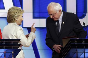 Democratic presidential candidate Hillary Clinton, left, gestures towards Democratic presidential candidate Sen. Bernie Sanders, I-Vt., at the start of a break during the CNN Democratic Presidential Primary Debate at the Brooklyn Navy Yard on Thursday, April 14, 2016 in New York.