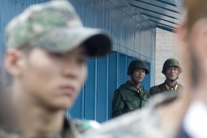 File - North Korean soldiers watch as South Korean Foreign Minister Yu Myung-hwan U.S. Secretary of State Hillary Rodham Clinton, U.S. Secretary of Defense Robert Gates and South Korean Defense Minister Kim Tae-young speak to members of the press outside the T2 buildings in Panmunjom, the demilitarized zone that separates the two Koreas since the Korean War, north of Seoul, South Korea, July 21, 2010.