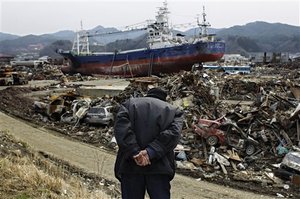 An eldery Japaneese man observes the area devastated by the March 11 earthquake and tsunami in the port town of Kesennuma, Miyagi prefecture, Japan, on Monday, April 11, 2011. Exactly a month ago today a massive earthquake and tsunami ravaged Japan's northeastern coastal region.