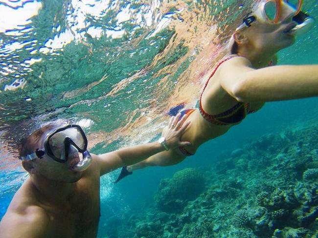 NRL player Sam Burgess posted this Instagram image swimming with sharks while on honeymoon in the Maldives with wife Phoebe Burgess.