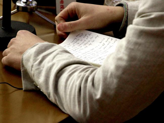 Contrite ... American student Otto Warmbier holds onto handwritten notes during his apology for an ‘hostile act’ in North Korea. Picture: AP Photo/Kim Kwang Hyon