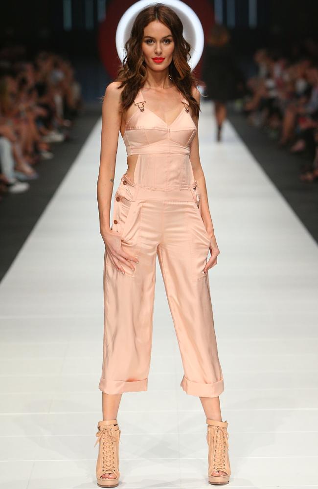 Fashion flashback. Nicole Trunfio in a pink jumpsuit inspired by the famous bra worn by Madonna. Picture: Graham Denholm