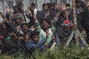 Migrants, most of them from Pakistan, protest against the EU- Turkey deal about migration inside the entrance of Moria camp in the Greek island of Lesbos on Tuesday, April 5, 2016