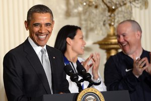 President Barack Obama laughs at a White House event honoring U.S. athletes from the 2014 Olympic and Paralympic Winter Games, Washington, D.C., April 3, 2014. Pictured with Obama are Julie Chu of Fairfield, Conn, who won silver with the women's Olympic ice hockey team; and (far right) Jon Lujan of Littleton, Colo., Paralympics Alpine Skiing, former Marine Corps sergeant and 2014 Winter Paralympic Games opening ceremony Team USA flag bearer