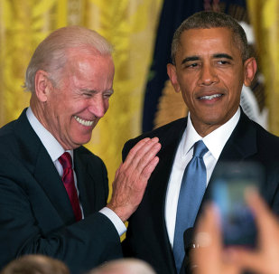 Vice President Joe Biden and President Barack Obama react after a heckler is removed from the East Room of the White House.