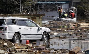 FILE:Rescue personnel on a rubber boat conduct search operation at submerged Sendai airport following a massive Tsunami triggered by a huge earth quake in Sendai, northern Japan, Saturday, March 12, 2011.