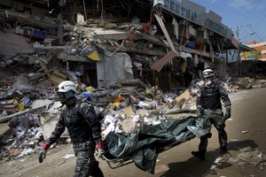 Rescue workers carry body bags in a basket stretcher, as they look for survivors after an earthquake, in Manta, Ecuador, Monday, April 18, 2016.