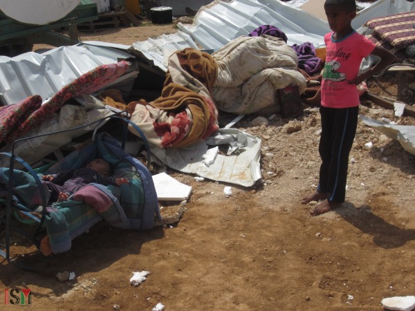 Children standing on the land of their now demolished homes, Um Al-Khair