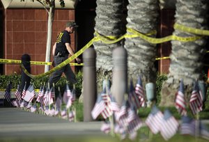 An investigator works the site of a mass shooting at the Inland Regional Center on Monday, Dec. 7, 2015 in San Bernardino, Calif.