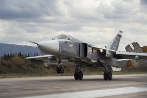 A Russian Su-24 bomber lands at Hemeimeem air base in Syria