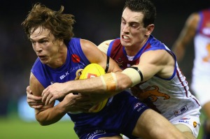 Gotcha: Liam Picken of the Bulldogs is locked up by Darcy Gardiner of the Lions.