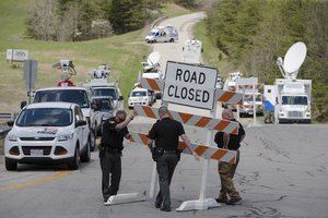 Authorities set up road blocks at the intersection of Union Hill Road and Route 32 at the perimeter of a crime scene, Friday, April 22, 2016, in Pike County, Ohio. Shootings with multiple fatalities were reported along a road in rural Ohio on Friday morning.