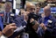 Specialist Jorge Fernandez, left, and trader James Riley work on the floor of the New York Stock Exchange, Friday, Aug. 28, 2015.