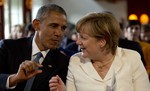 German Chancellor Angela Merkel, right, speaks with U.S. President Barack Obama during a concert at the G-7 summit at Schloss Elmau hotel near Garmisch-Partenkirchen, southern Germany, Sunday, June 7, 2015. The two-day summit will address such issues as climate change, poverty and the situation in Ukraine.