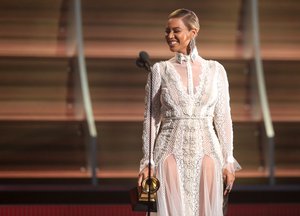 Beyonce presents the award for record of the year at the 58th annual Grammy Awards on Monday, Feb. 15, 2016, in Los Angeles.