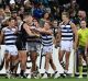 Geelong and Port Adelaide players wrestle at the quarter-time break.