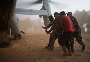 File - An Air Force pararescueman with Joint Task Force 505 helps evacuate earthquake victims near Cherikot, Nepal, May 12. The task force, other multinational forces and humanitarian relief organizations provided aid after a 7.8 magnitude earthquake struck the country April 25, 2015.