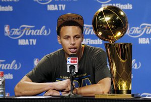 Golden State Warriors guard Stephen Curry (30) responds to a question during a news conference following Game 6 of basketball's NBA Finals against the Cleveland Cavaliers, in Cleveland, Wednesday, June 17, 2015. The Warriors defeated the Cavaliers 105-97 to win the best-of-seven game series 4-2. (AP Photo/Paul Sancya)