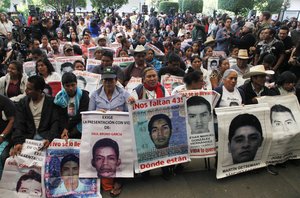 Relatives of the 43 missing students listen to the international experts group's report, in Mexico City, Sunday, April 24, 2016.