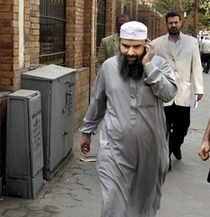 In this April 11, 2007 file photo, Egyptian cleric Osama Hassan Mustafa Nasr, also known as Abu Omar, who was allegedly kidnapped by CIA agents off the streets of an Italiancity and taken to Egypt where he said he was tortured, talks on his mobile phone as he walks in a Cairo street after attending an Amnesty International press conference in Cairo, Egypt. On Tuesday, Feb. 23, 2016, the European Court of Human Rights ruled Italy abused state secrecy to provide impunity in the 2003 abduction of the Egyptian cleric, who was spirited out of Italy for interrogation and torture in his homeland under the CIA’s extraordinary rendition program. (AP Photo/Amr Nabil, File)