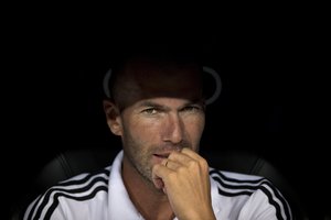 FILE - In this Aug. 22, 2013 file photo, Real Madrid's current B team coach Zinedine Zidane sits on the bench during the Santiago Bernabeu trophy soccer match against Al Sadd at the Santiago Bernabeu stadium, in Madrid, Spain.