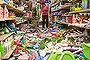 Nina Quidit cleans up the Dollar Plus and Party Supplies Store in American Canyon Calif. after an earthquake on Sunday Aug. 24, 2014. Quidit and her husband were woken up in the early morning hours by the store's alarm company and immediately drove in to begin clean up. The 6.0-magnitude quake caused six significant fires, including at four mobile homes, Napa Division Fire Chief Darren Drake said. (AP Photo/Alex Washburn)