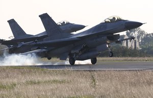 Two F-16 fighter jets land during an emergency drill at the air force base in Chiayi, Taiwan, Tuesday, Jan. 26, 2016.