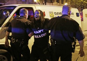 A protester is arrested after the acquittal of Michael Brelo, a patrolman charged in the shooting deaths of two unarmed suspects Saturday, May 23, 2015, in Cleveland.