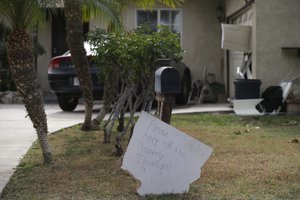 A sign stands in front of a mailbox at Enrique Marquez's home, Wednesday, Dec. 9, 2015, in Riverside, Calif.