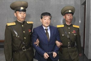 Kim Dong Chul, center, a U.S. citizen detained in North Korea, is escorted to his trial Friday, April 29, 2016, in Pyongyang, North Korea.